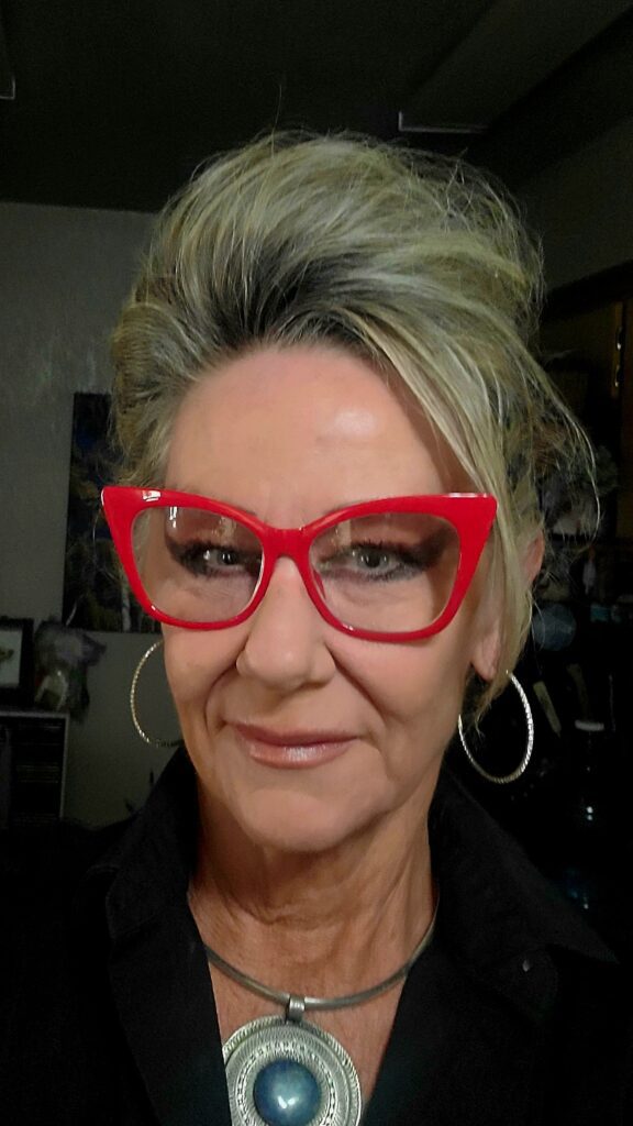 Woman wearing red cat-eye glasses and necklace