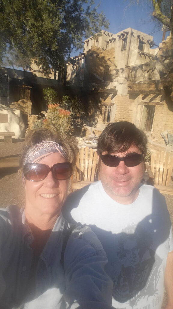 Two people wearing sunglasses taking outdoor selfie