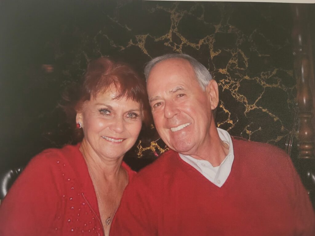 Smiling elderly couple wearing red sweaters