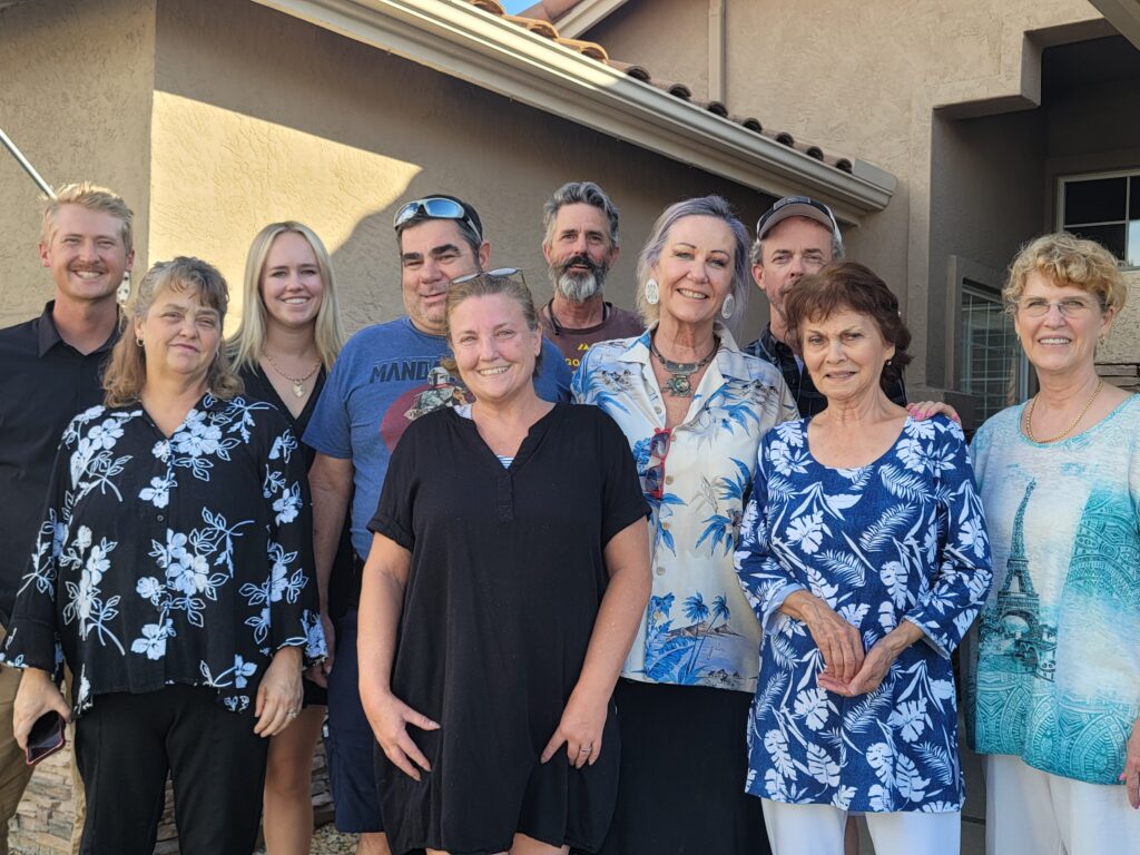 Smiling multigenerational group outside house