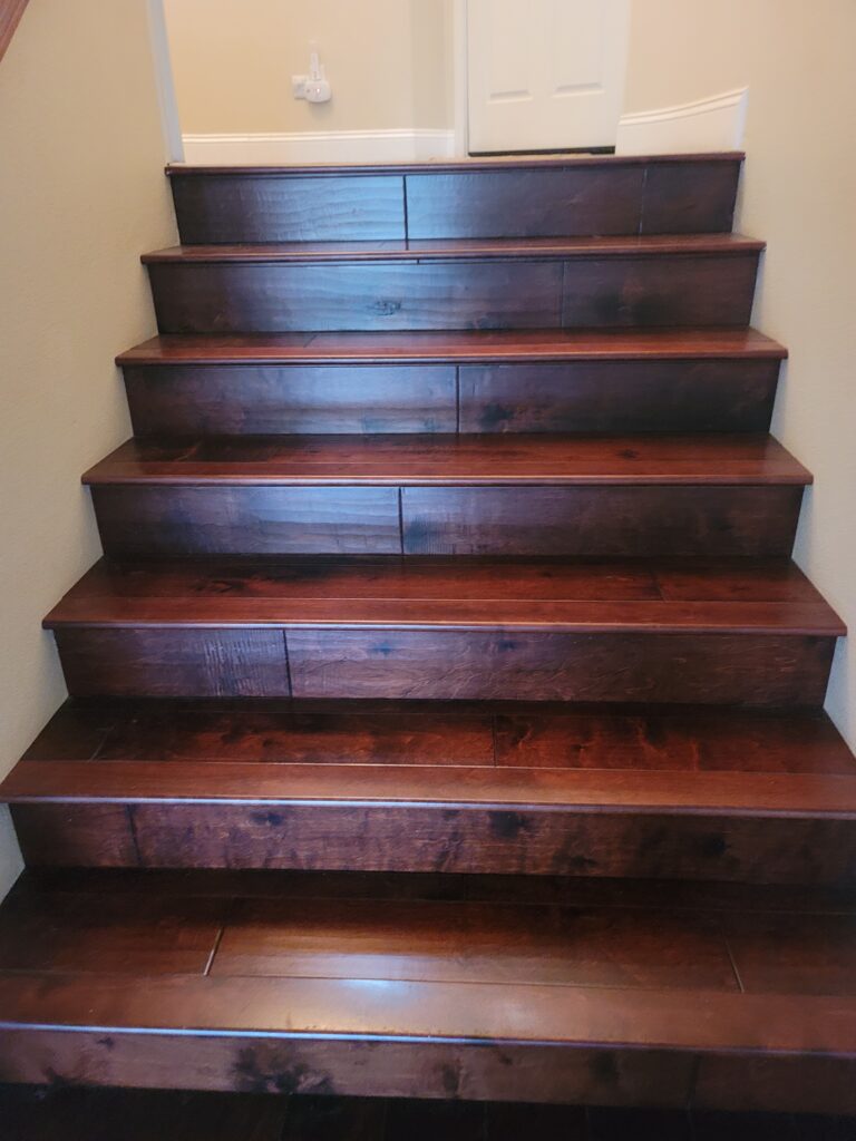 Dark hardwood stairs ascending to upper landing
