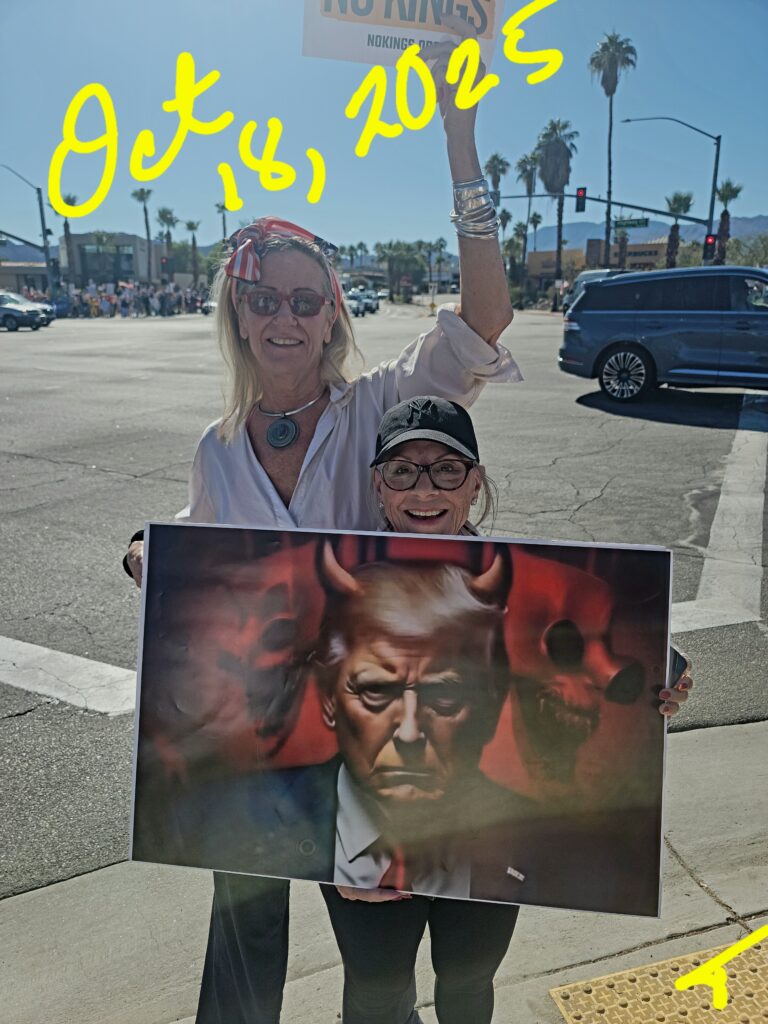 Two people holding devilish portrait poster