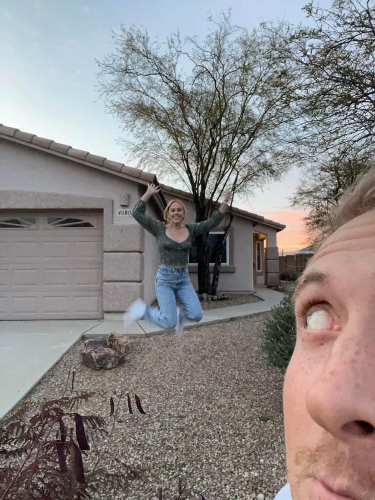 Man peeking selfie with woman jumping outside